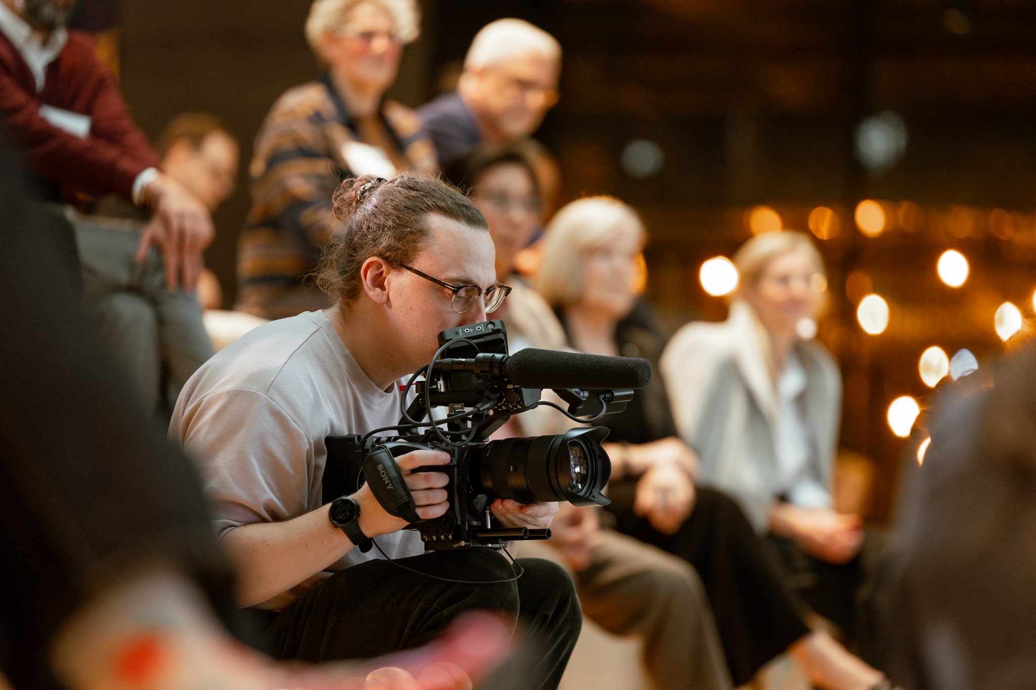 An event videographer in Calgary captures dynamic footage of attendees networking, highlighting the energy of a corporate function.
