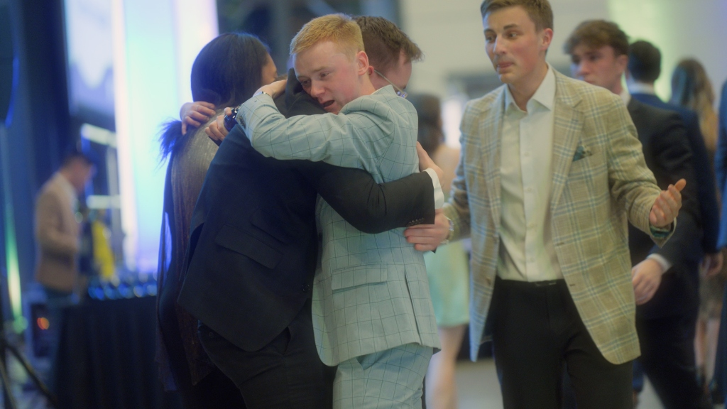Delegates embracing in celebration at the JDC West closing gala